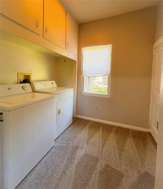 8106 Oak St, Kansas City, MO 64114 - laundry area with washing machine and dryer, cabinet space, light colored carpet, and baseboards