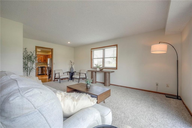 1101 Jeff Cir, Paola, KS 66071 - carpeted living area with a textured ceiling and baseboards