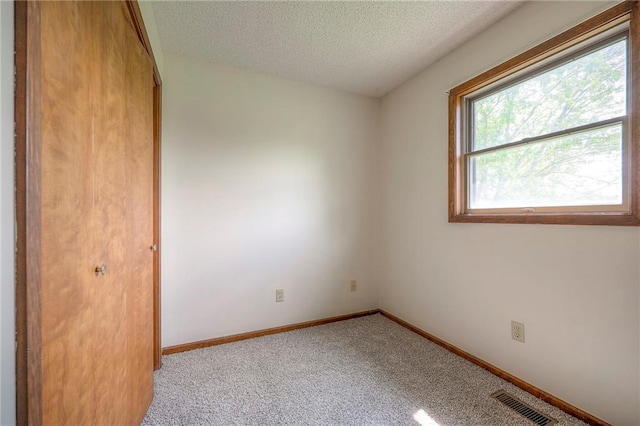 1101 Jeff Cir, Paola, KS 66071 - unfurnished bedroom with a textured ceiling, light carpet, baseboards, and a closet