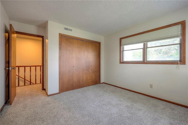 1101 Jeff Cir, Paola, KS 66071 - unfurnished bedroom with carpet flooring, a closet, a textured ceiling, and baseboards
