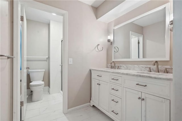7710 Noland Rd, Lenexa, KS 66216 - full bath with marble finish flooring, toilet, double vanity, and baseboards