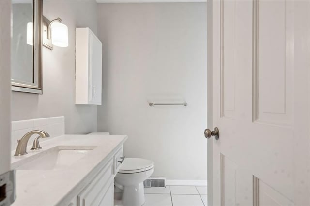 7710 Noland Rd, Lenexa, KS 66216 - bathroom featuring tile patterned floors, toilet, vanity, and baseboards