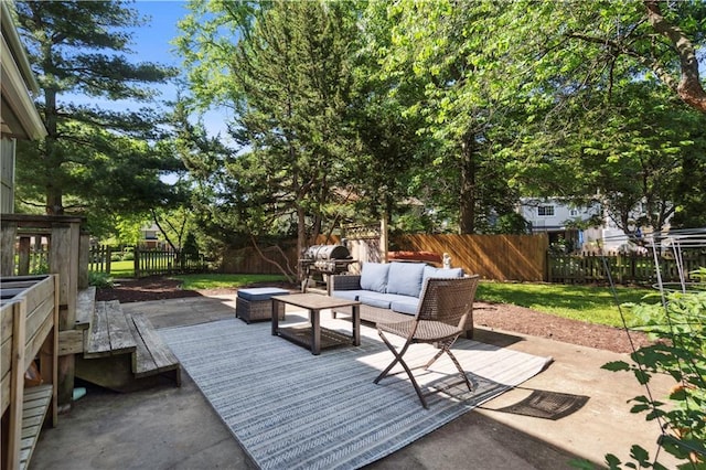 7710 Noland Rd, Lenexa, KS 66216 - fenced backyard with an outdoor hangout area, grilling area, and a patio area