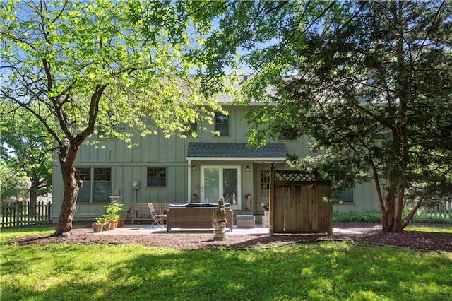 7710 Noland Rd, Lenexa, KS 66216 - back of house with a patio, board and batten siding, and a shingled roof