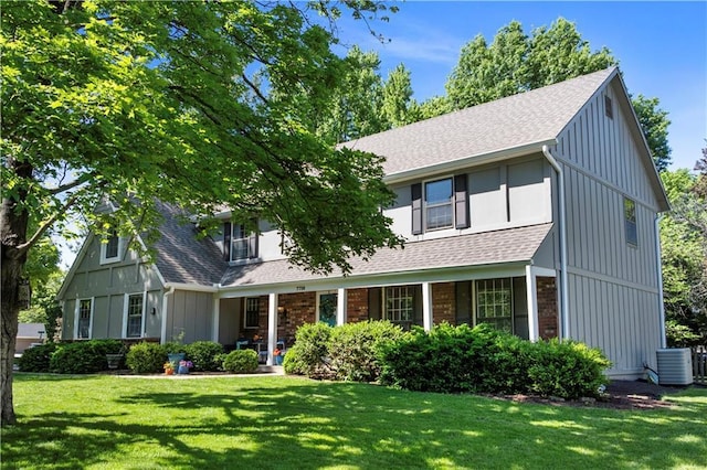 7710 Noland Rd, Lenexa, KS 66216 - view of front of house featuring cooling unit, a front lawn, and roof with shingles