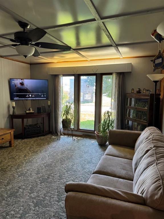 205 N Cherokee St, Girard, KS 66743 - carpeted living room featuring a ceiling fan and wood walls