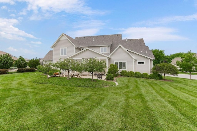 10309 S Oakcrest Ln, Olathe, KS 66061 - view of side of home with a patio area, a lawn, and a shingled roof