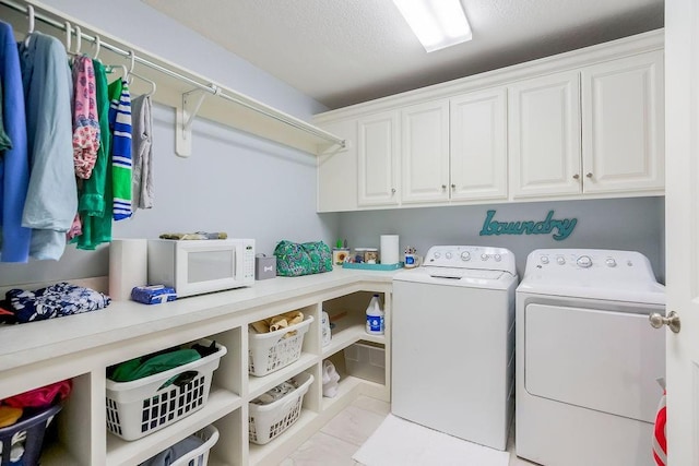 10309 S Oakcrest Ln, Olathe, KS 66061 - washroom with washing machine and clothes dryer and cabinet space