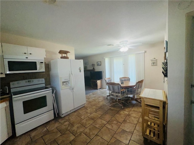 505 W 3rd Ave, Garnett, KS 66032 - kitchen featuring white appliances, ceiling fan, and white cabinets