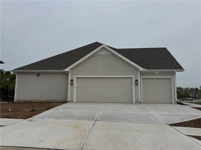 11494 S Longview Rd, Olathe, KS 66061 - view of front of home featuring an attached garage, concrete driveway, roof with shingles, and stucco siding