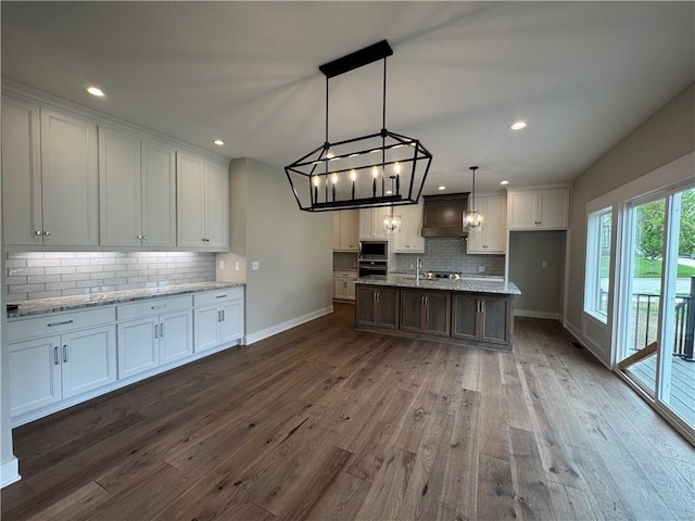 11494 S Longview Rd, Olathe, KS 66061 - kitchen featuring baseboards, custom range hood, appliances with stainless steel finishes, decorative backsplash, and white cabinets