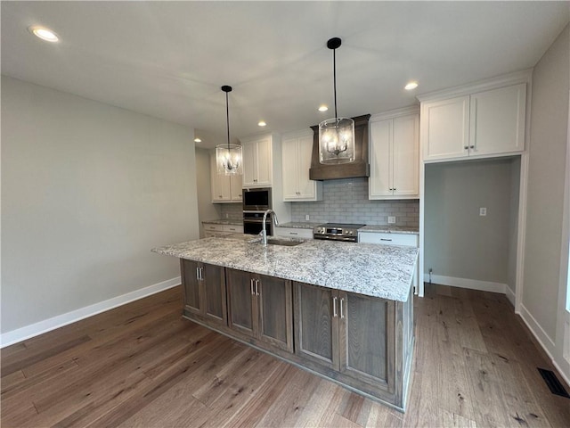 11494 S Longview Rd, Olathe, KS 66061 - kitchen featuring custom range hood, appliances with stainless steel finishes, a sink, baseboards, and white cabinetry