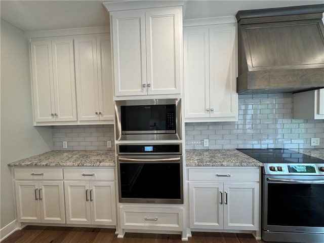11494 S Longview Rd, Olathe, KS 66061 - kitchen featuring appliances with stainless steel finishes, premium range hood, white cabinets, and decorative backsplash