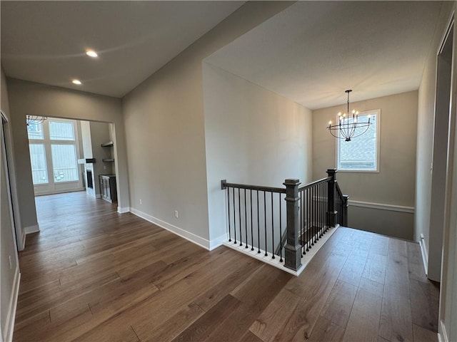 11494 S Longview Rd, Olathe, KS 66061 - corridor featuring dark wood-style flooring, a chandelier, an upstairs landing, recessed lighting, and baseboards
