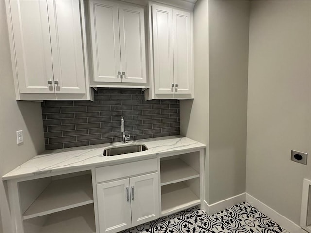 11494 S Longview Rd, Olathe, KS 66061 - washroom with hookup for an electric dryer, baseboards, cabinet space, and tile patterned floors