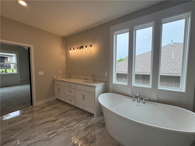 11494 S Longview Rd, Olathe, KS 66061 - bathroom featuring a sink, a soaking tub, marble finish floors, baseboards, and recessed lighting