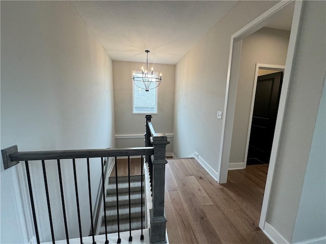 11494 S Longview Rd, Olathe, KS 66061 - staircase with wood finished floors, a chandelier, and baseboards
