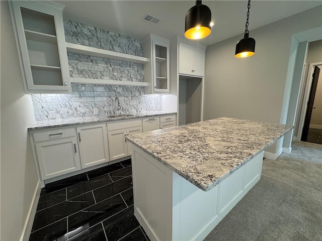 11494 S Longview Rd, Olathe, KS 66061 - kitchen featuring a sink, white cabinets, glass insert cabinets, and a center island