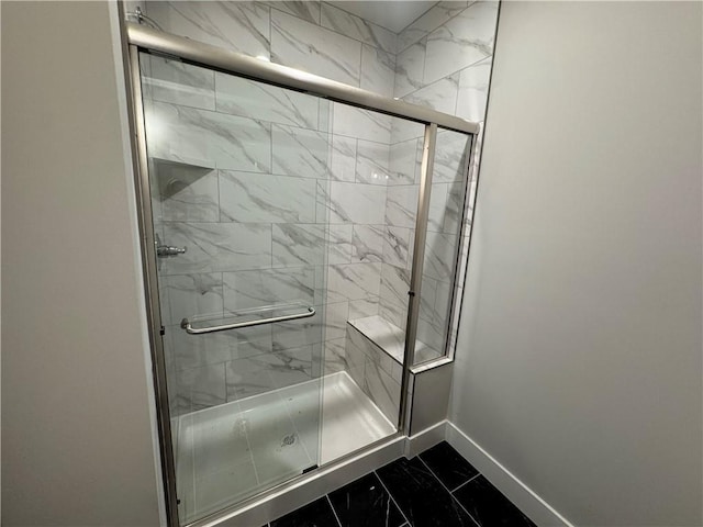 11494 S Longview Rd, Olathe, KS 66061 - bathroom featuring baseboards, marble finish floors, and a shower stall