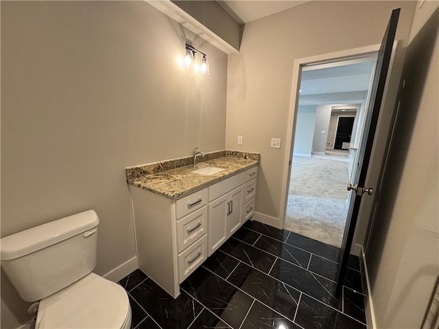 11494 S Longview Rd, Olathe, KS 66061 - bathroom with baseboards, toilet, vanity, and marble look tiles