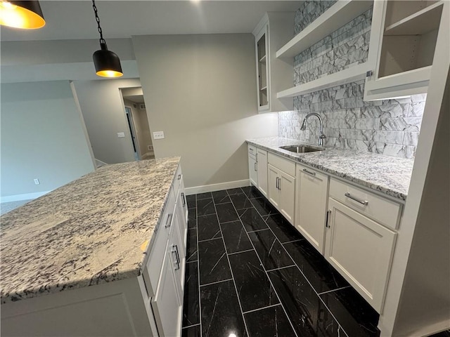 11494 S Longview Rd, Olathe, KS 66061 - kitchen with a sink, dark marble finish floors, open shelves, baseboards, and glass insert cabinets