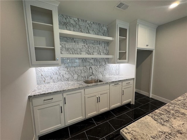 11494 S Longview Rd, Olathe, KS 66061 - kitchen with a sink, white cabinetry, glass insert cabinets, baseboards, and decorative backsplash