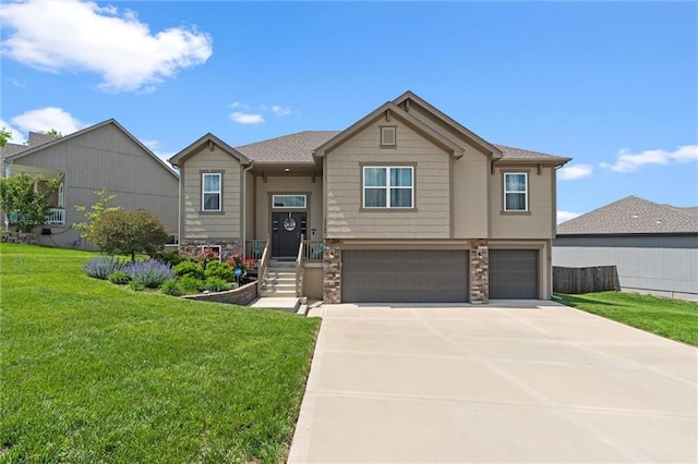 15700 NW 122nd St, Platte City, MO 64079 - bi-level home featuring a garage, stone siding, a front lawn, and concrete driveway