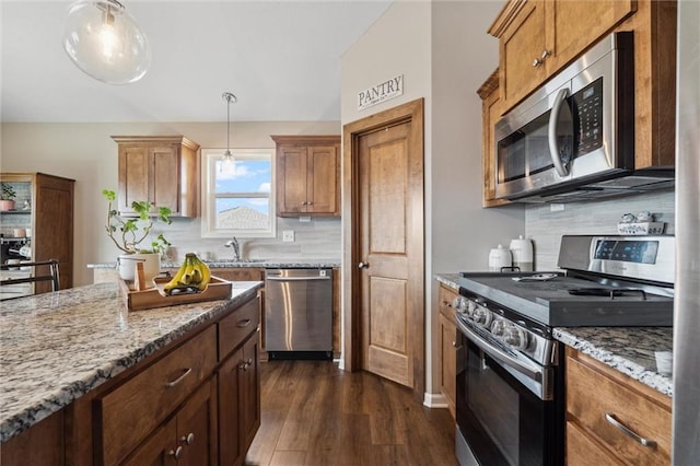 15700 NW 122nd St, Platte City, MO 64079 - kitchen featuring appliances with stainless steel finishes, dark wood-style floors, a sink, light stone counters, and backsplash