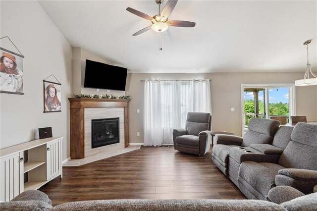 15700 NW 122nd St, Platte City, MO 64079 - living area featuring ceiling fan, dark wood-style floors, a tile fireplace, and vaulted ceiling