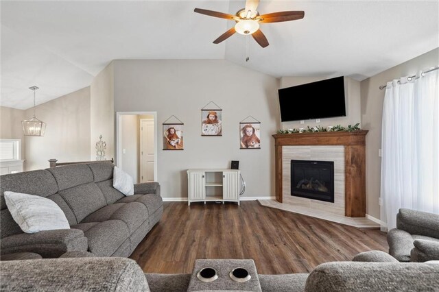 15700 NW 122nd St, Platte City, MO 64079 - living room featuring vaulted ceiling, baseboards, a ceiling fan, a fireplace, and a chandelier