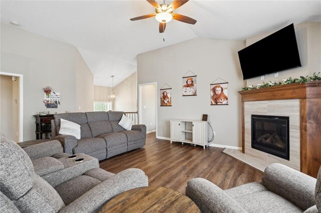15700 NW 122nd St, Platte City, MO 64079 - living area featuring lofted ceiling, a ceiling fan, wood finished floors, baseboards, and a tiled fireplace