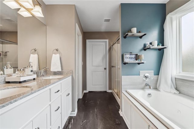 15700 NW 122nd St, Platte City, MO 64079 - bathroom featuring a stall shower, a garden tub, double vanity, and baseboards