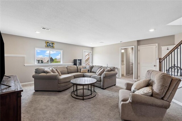 15700 NW 122nd St, Platte City, MO 64079 - living room with carpet, stairway, a textured ceiling, baseboards, and recessed lighting