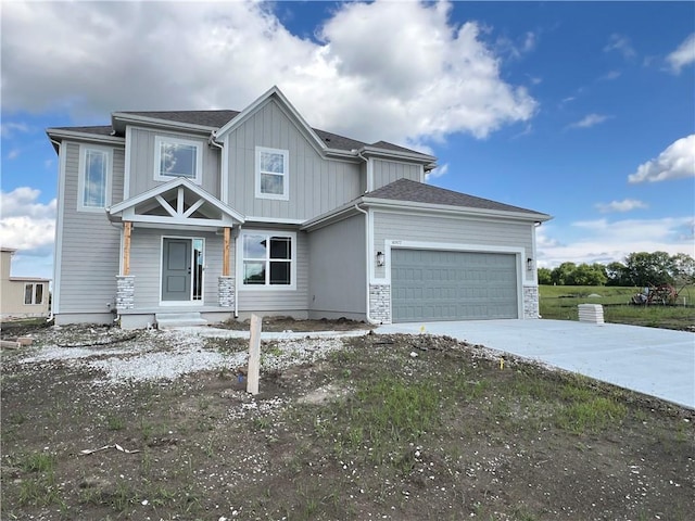 16977 S Mahaffie St, Olathe, KS 66062 - view of front of home with concrete driveway, a garage, and board and batten siding