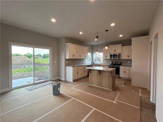 16977 S Mahaffie St, Olathe, KS 66062 - kitchen featuring appliances with stainless steel finishes, backsplash, a sink, white cabinetry, and recessed lighting