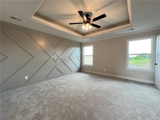 16977 S Mahaffie St, Olathe, KS 66062 - empty room featuring a tray ceiling, a ceiling fan, carpet, baseboards, and ornamental molding