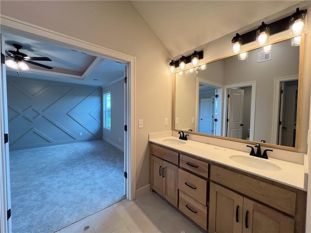 16977 S Mahaffie St, Olathe, KS 66062 - bathroom with double vanity, vaulted ceiling, ceiling fan, tile patterned flooring, and baseboards