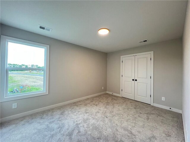 16977 S Mahaffie St, Olathe, KS 66062 - unfurnished bedroom with carpet, baseboards, and a closet