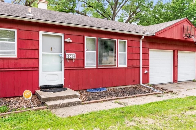 6014 Kentucky Rd, Raytown, MO 64133 - entrance to property with roof with shingles, a chimney, and an attached garage