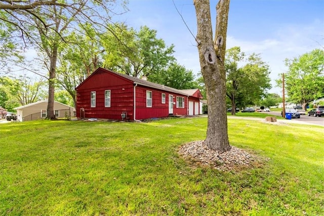 6014 Kentucky Rd, Raytown, MO 64133 - view of property exterior with a yard, an attached garage, and a chimney