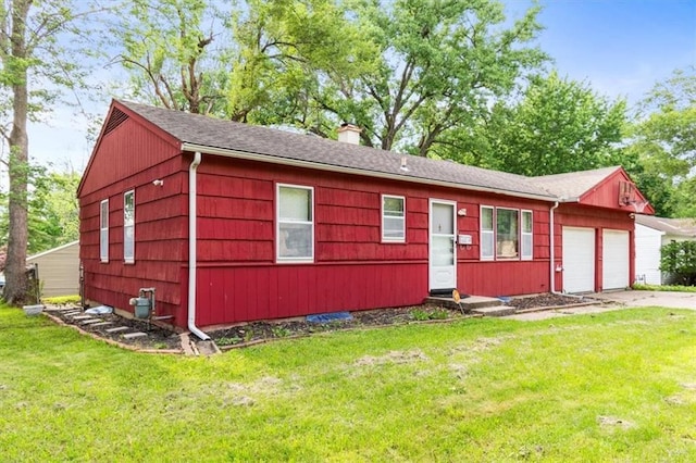 6014 Kentucky Rd, Raytown, MO 64133 - view of front facade featuring an attached garage, a chimney, a front lawn, and driveway