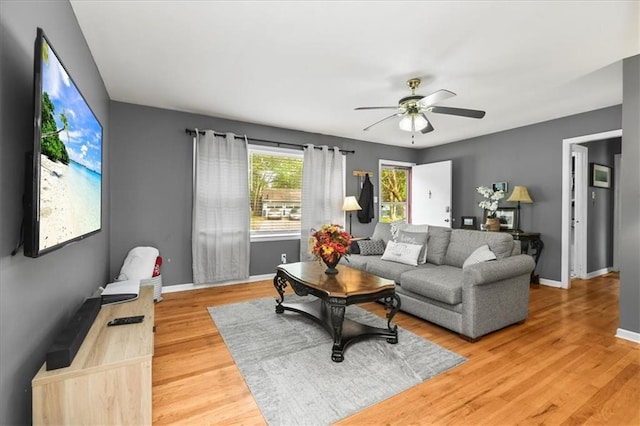 6014 Kentucky Rd, Raytown, MO 64133 - living area with a ceiling fan, light wood-type flooring, and baseboards