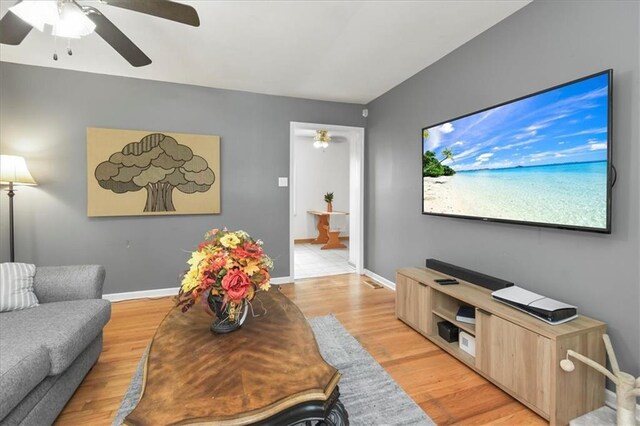 6014 Kentucky Rd, Raytown, MO 64133 - living area with ceiling fan, light wood finished floors, and baseboards