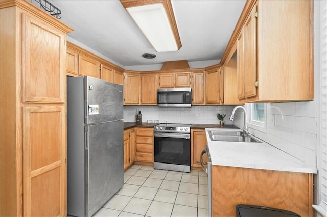 6014 Kentucky Rd, Raytown, MO 64133 - kitchen with stainless steel appliances, a sink, light tile patterned floors, and backsplash