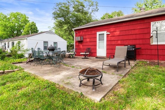6014 Kentucky Rd, Raytown, MO 64133 - view of patio / terrace featuring a fire pit, a wall mounted air conditioner, and a grill
