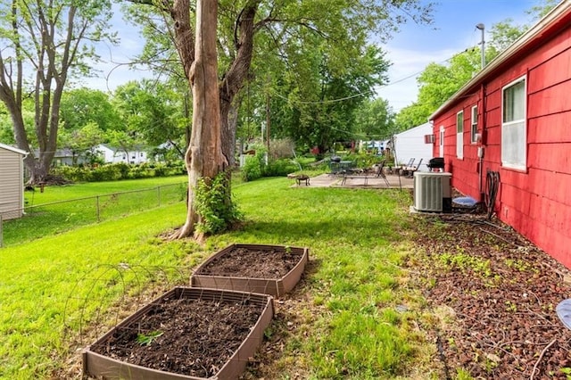 6014 Kentucky Rd, Raytown, MO 64133 - view of yard featuring a garden, central air condition unit, and a patio area
