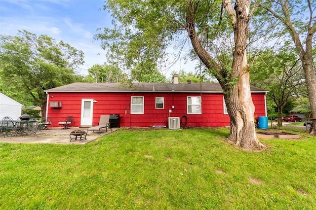 6014 Kentucky Rd, Raytown, MO 64133 - rear view of property featuring a patio, a lawn, and a fire pit