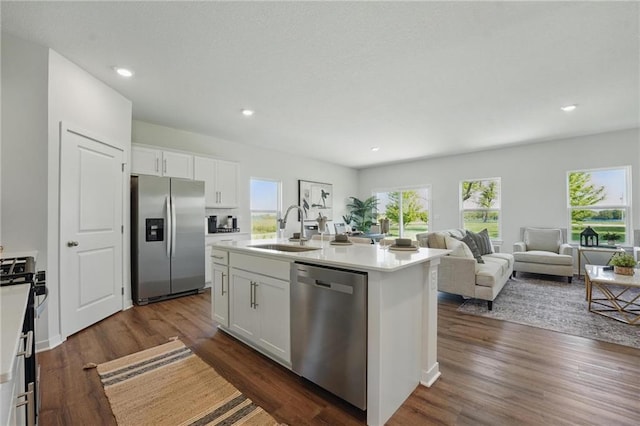 24810 178th Ct, Gardner, KS 66030 - kitchen with appliances with stainless steel finishes, a sink, white cabinets, open floor plan, and dark wood finished floors