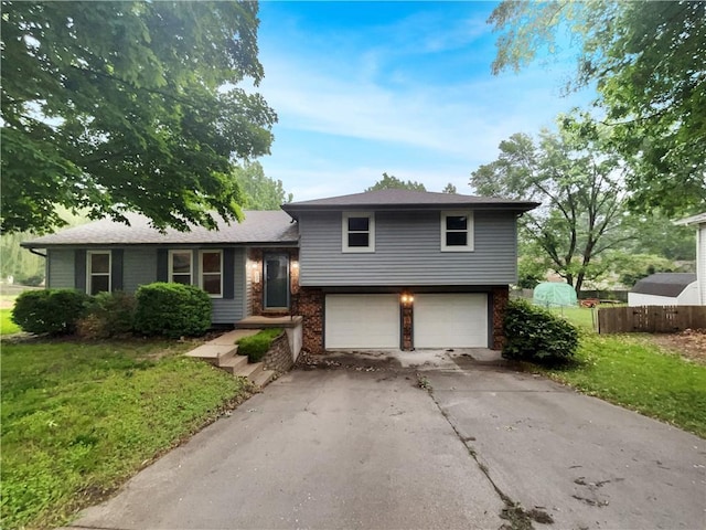 131 Brookridge St, Lansing, KS 66043 - tri-level home featuring an attached garage, driveway, and brick siding