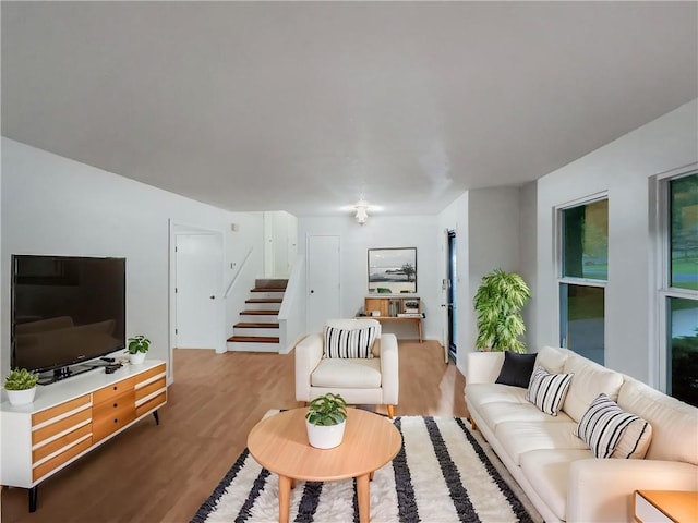 131 Brookridge St, Lansing, KS 66043 - living room featuring stairway and wood finished floors